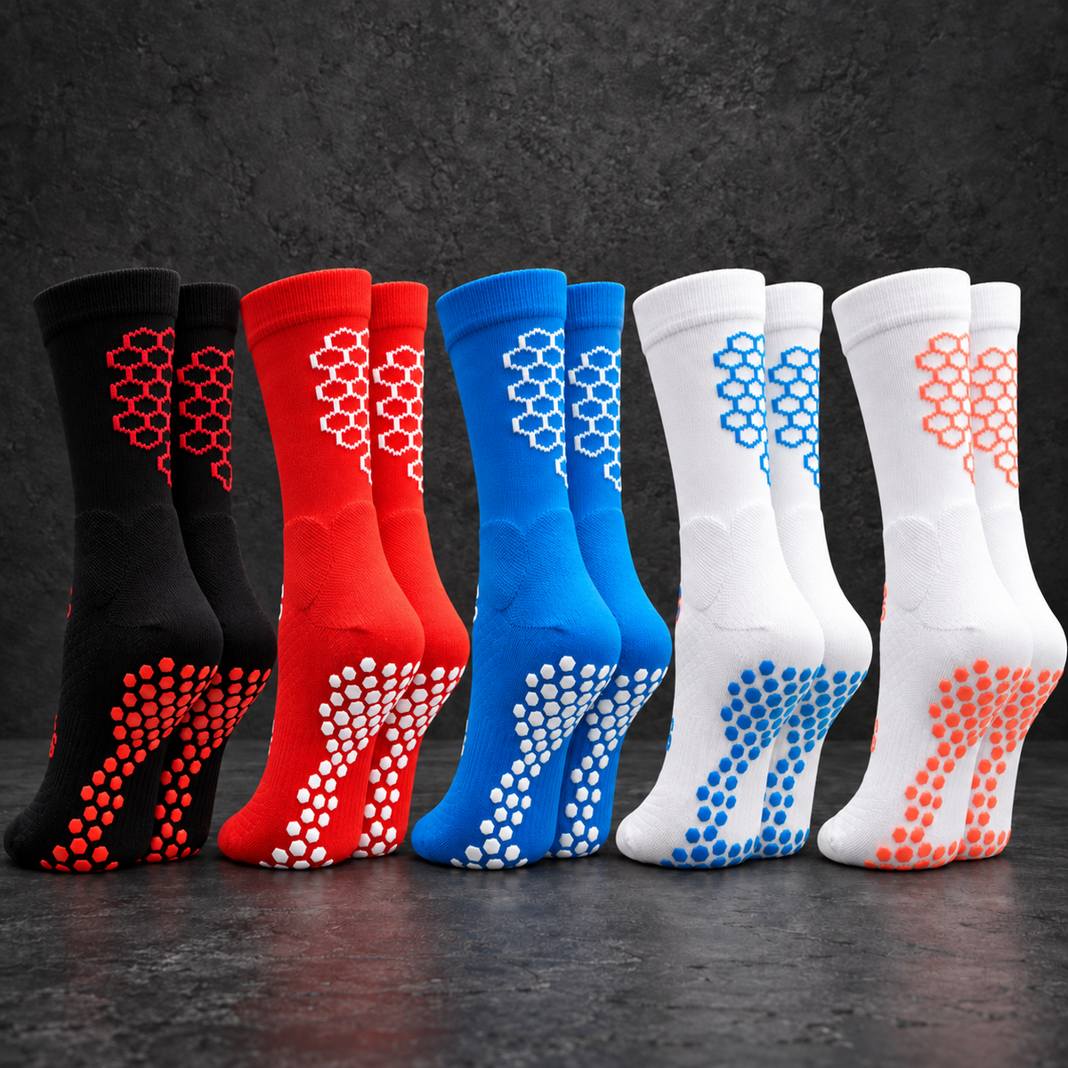 Five pairs of SOCKA grip socks in black/red, red/white, blue/white, white/blue and white/coral, viewed from the back.