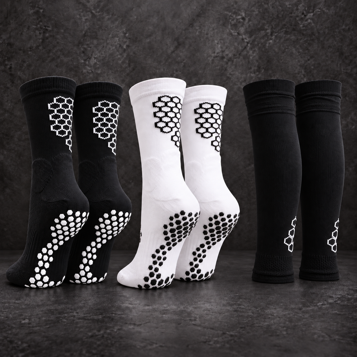 Black/white and white/black SOCKA grip socks with black football tubes.